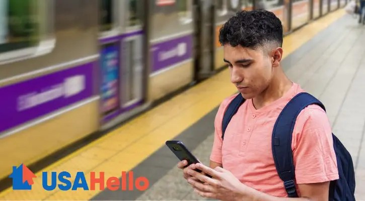 man looking at Immigration Guide on phone at subway stop